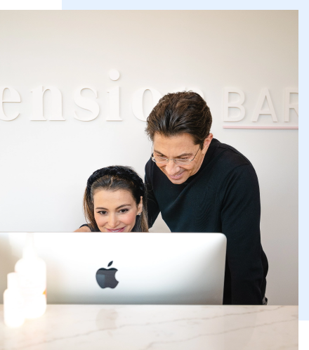 Dean Graziosi and his wife Lisa (Palacios) Graziosi at a mac computer.